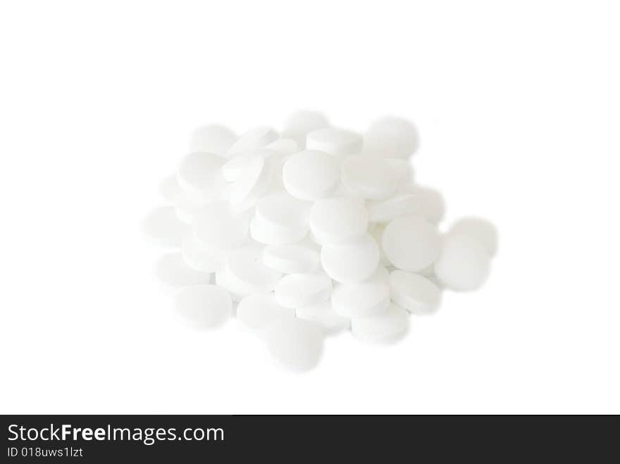 White round vitamins on the white isolated background