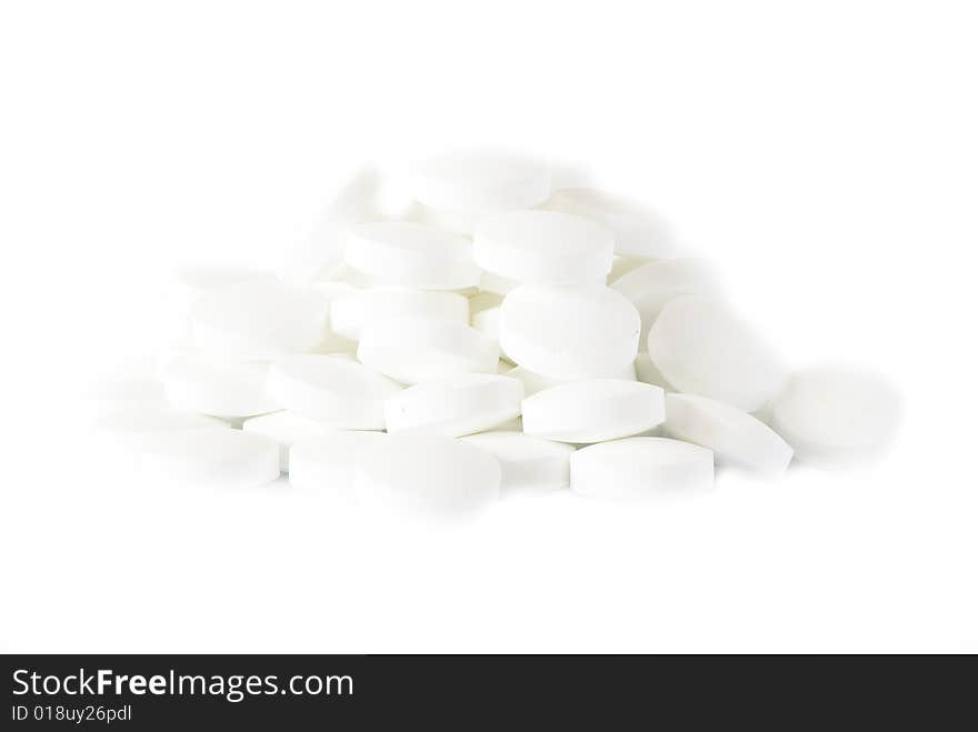 White round vitamins on the white isolated background