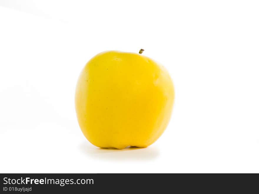 Yellow apple with shade on the isolated background