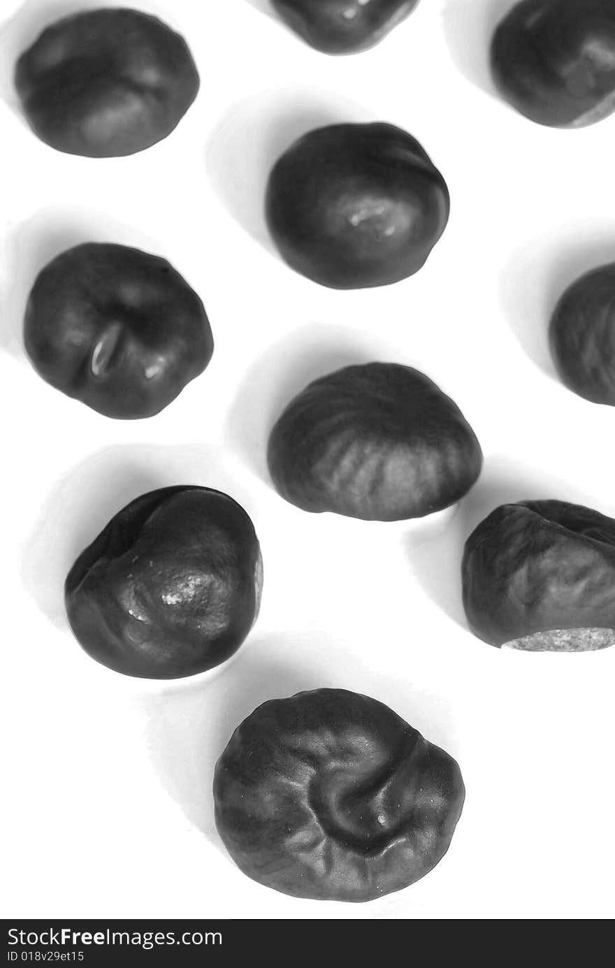 A few brown chestnuts are on a white background