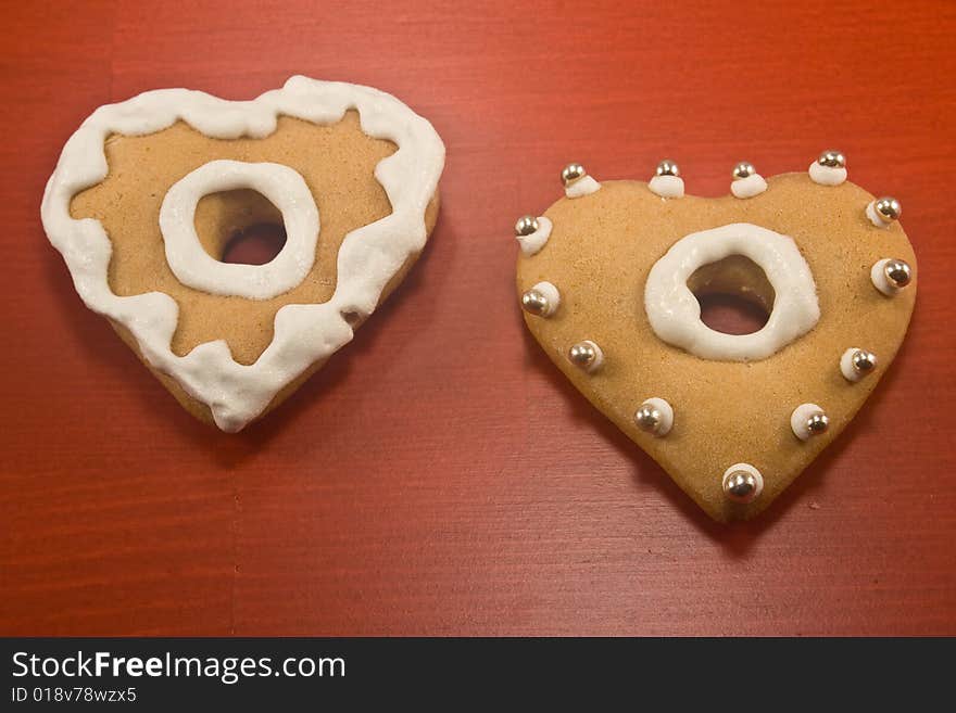 Decorated heart shaped cookies on red background. Decorated heart shaped cookies on red background