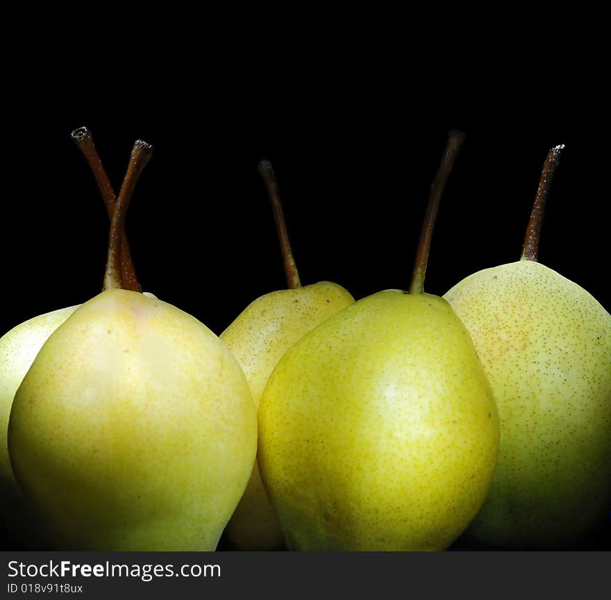 Juicy pears on black background.