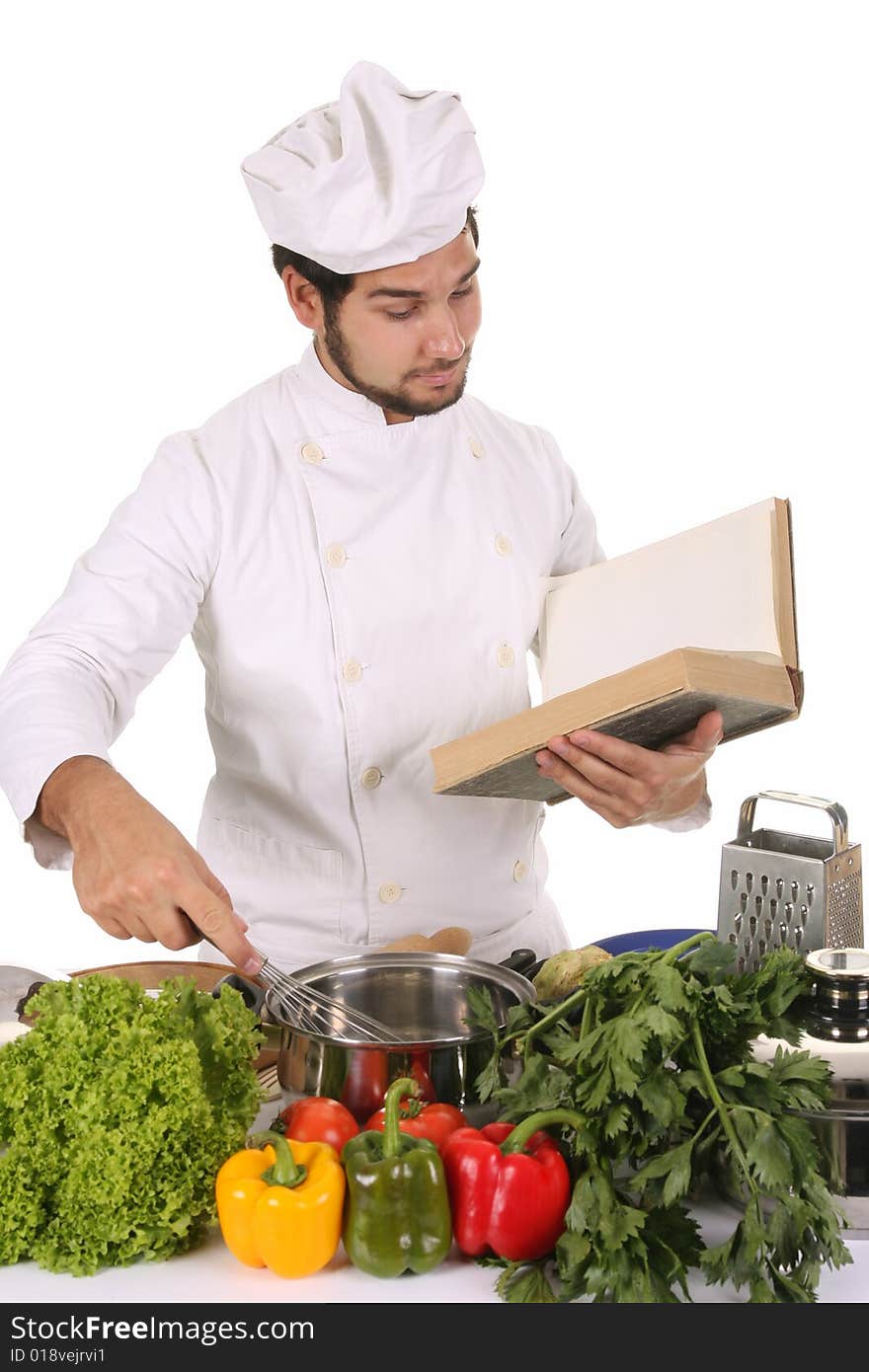 Young chef preparing lunch on white background