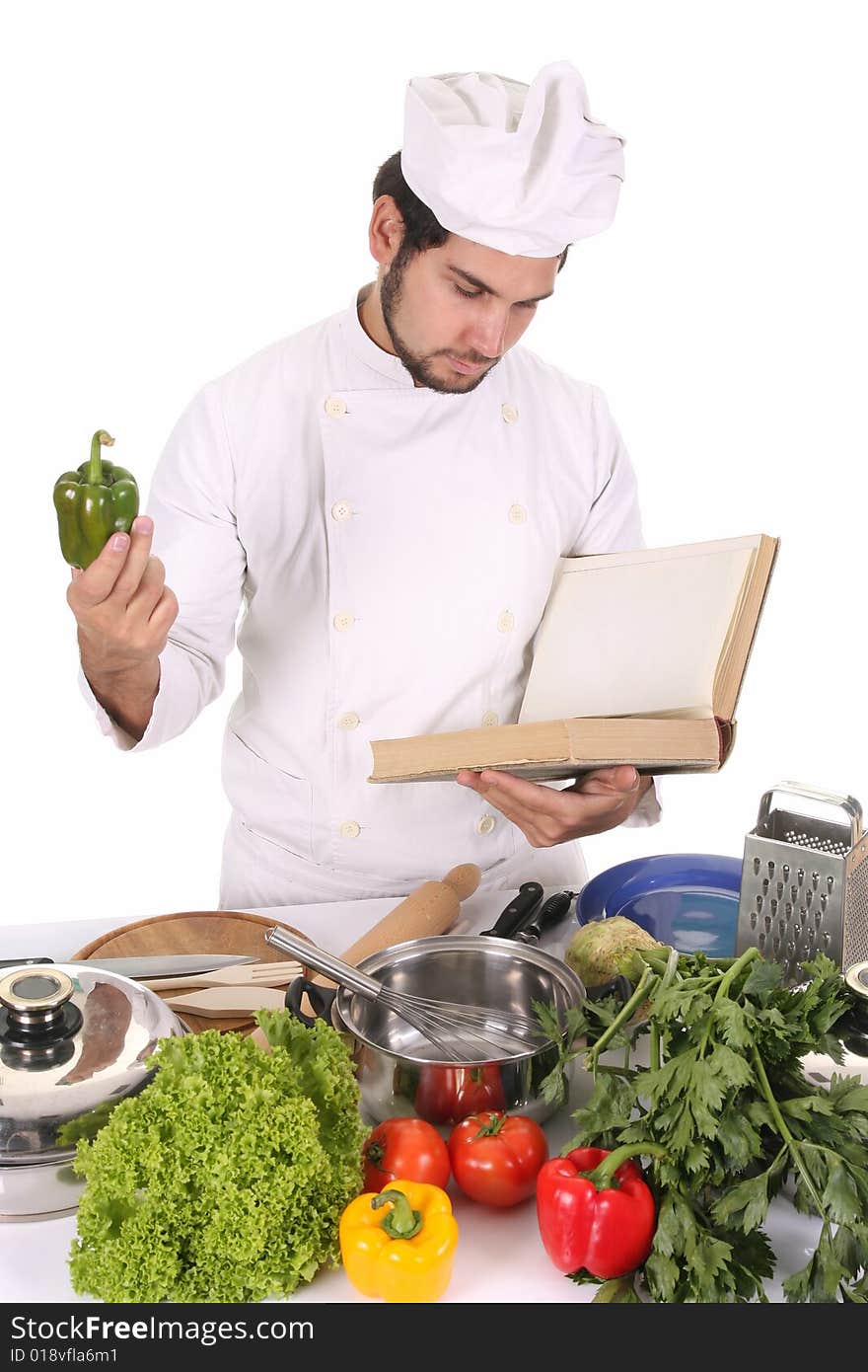 Young chef preparing lunch on white background