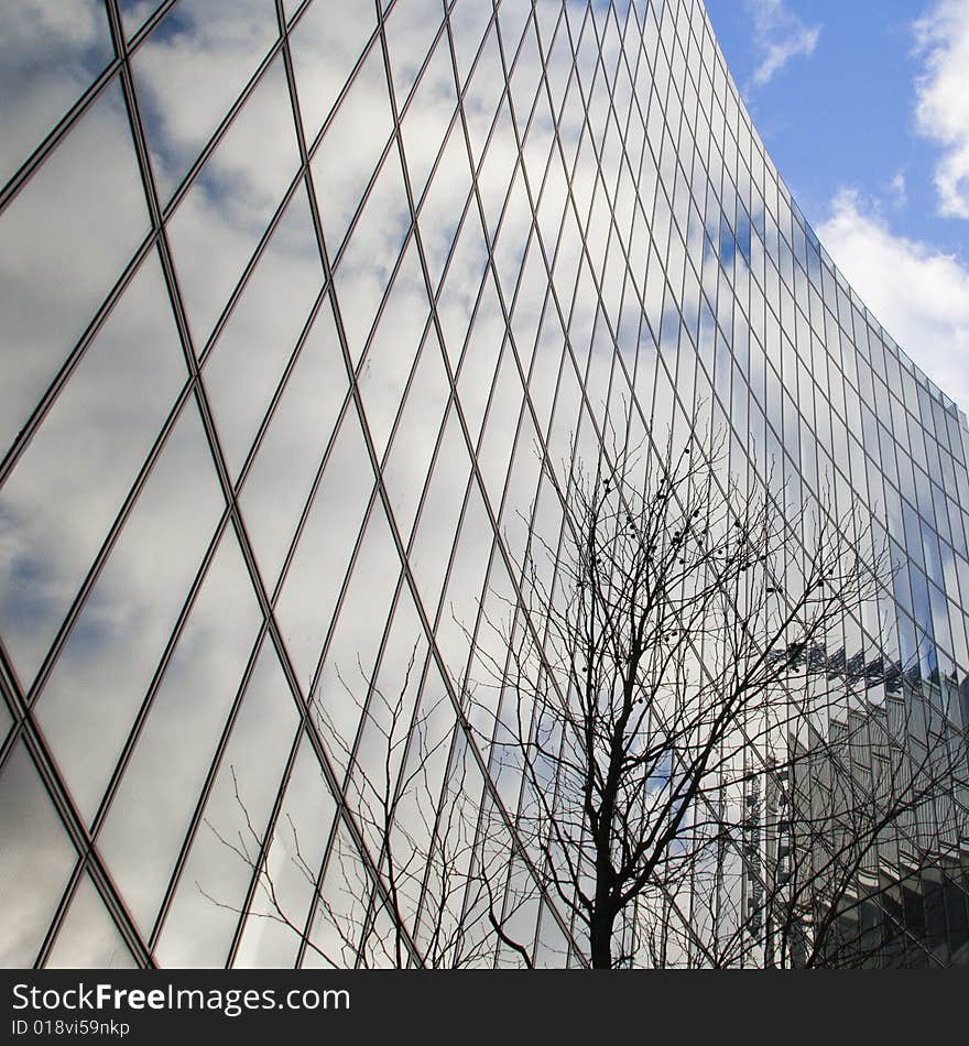 Wall of office building and sky reflction in the windows. Wall of office building and sky reflction in the windows