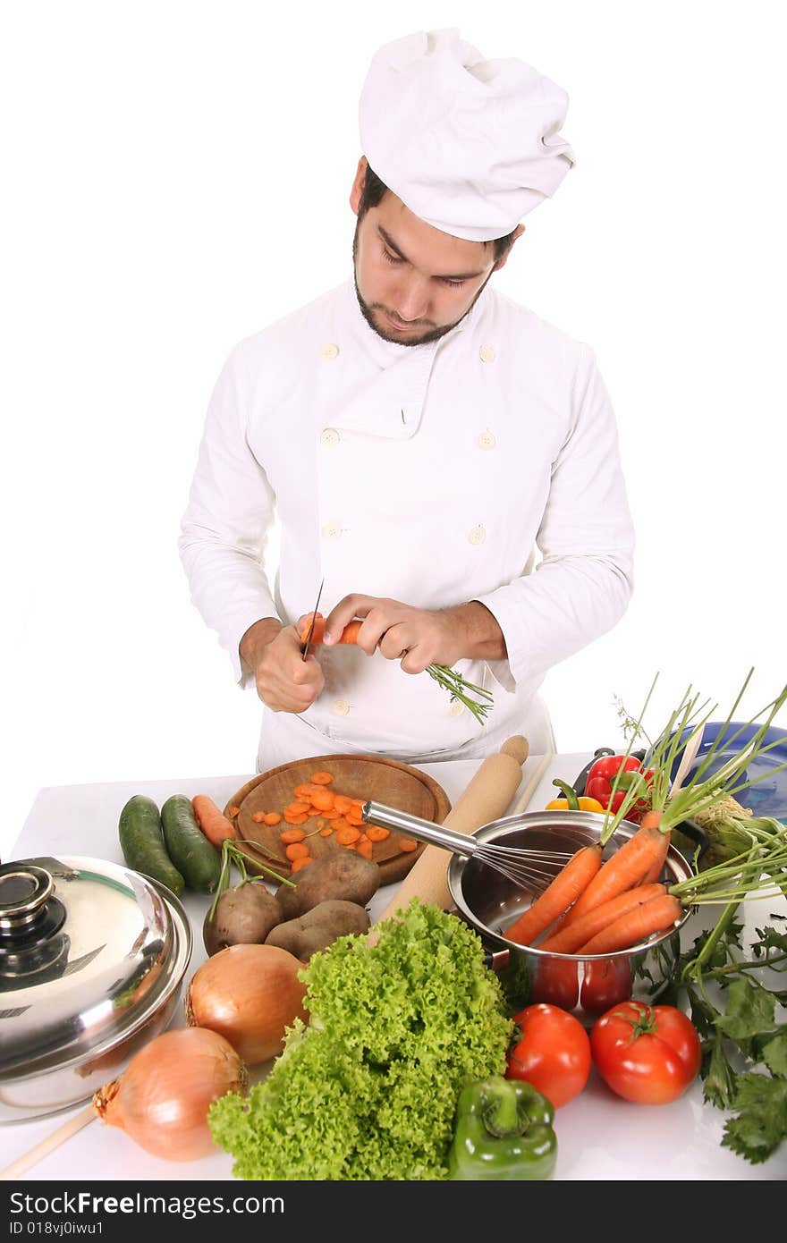 Young chef preparing lunch on white background