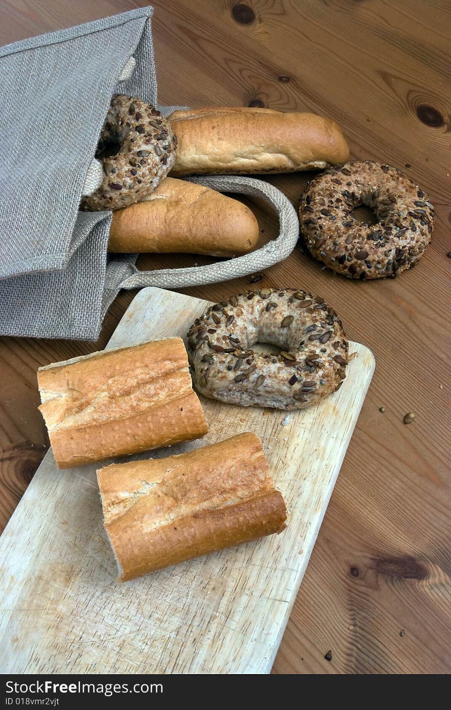 Fresh bread on a chopping board with natural bag. Fresh bread on a chopping board with natural bag