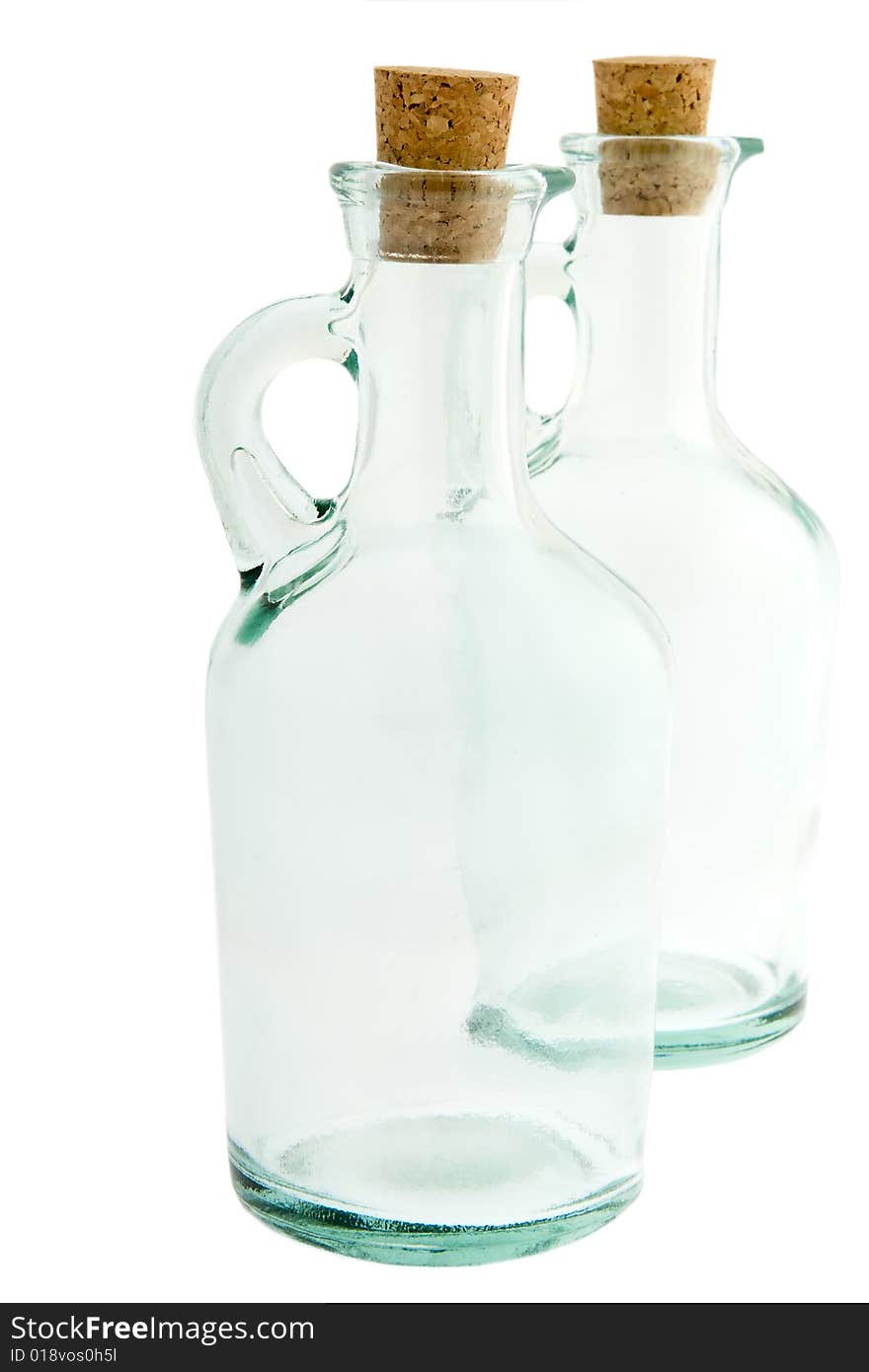 Bottle made of glass with corks, against a white background isolates