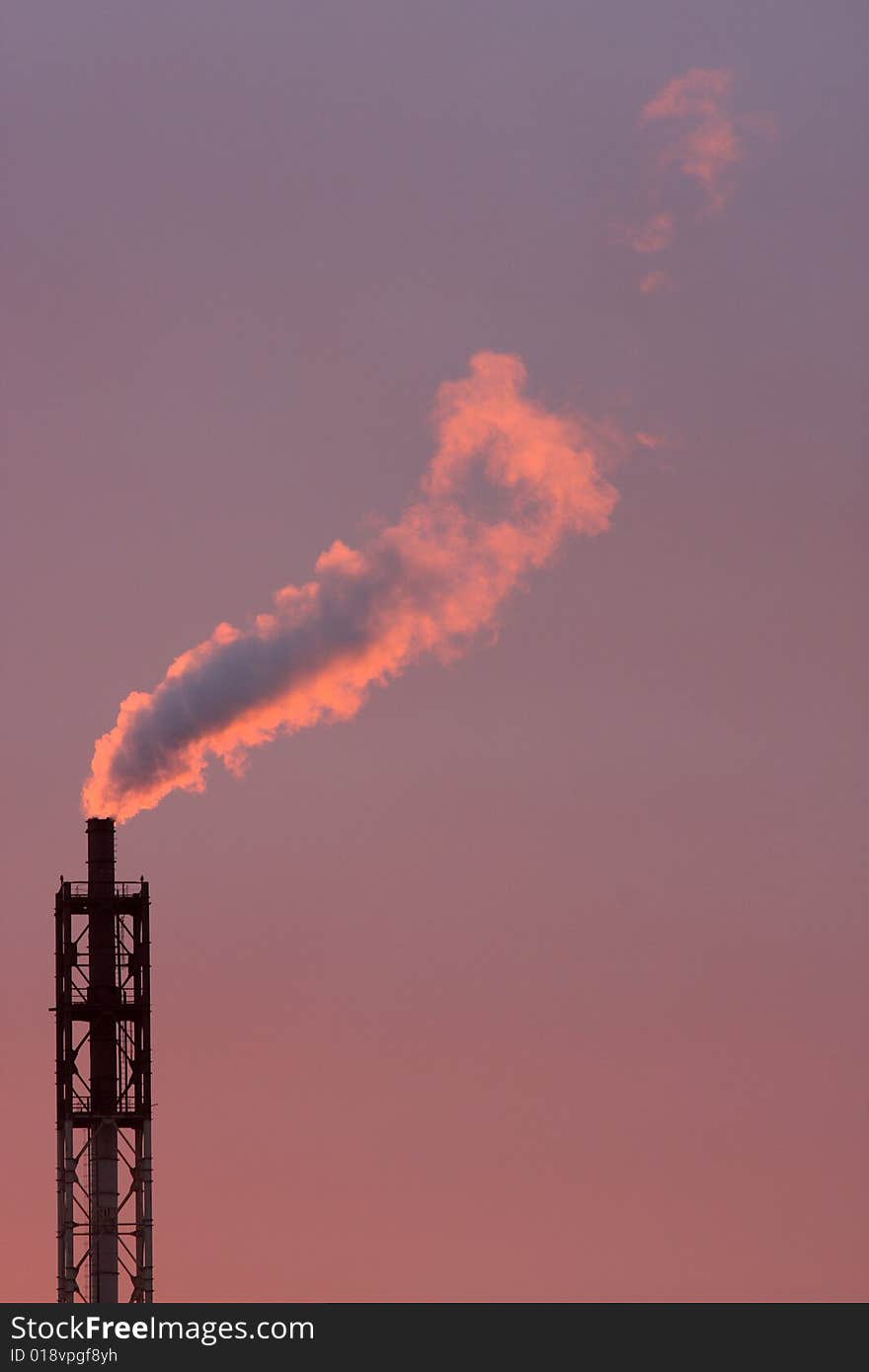 Smoke coming off the industrial stack in the light of sunset. Smoke coming off the industrial stack in the light of sunset.