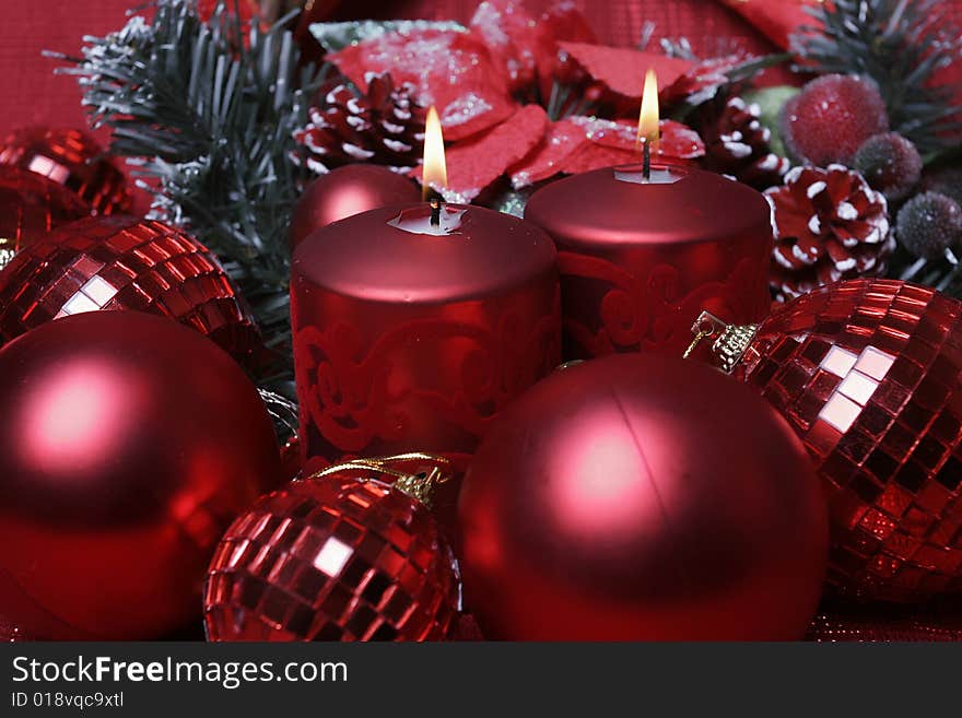 Closeup shot of red candle in christmas decoration. Closeup shot of red candle in christmas decoration