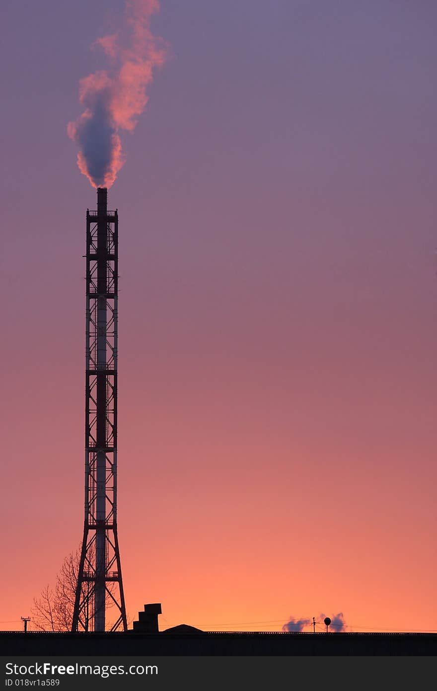 Smoke coming off the industrial stack in the light of sunset. Smoke coming off the industrial stack in the light of sunset.