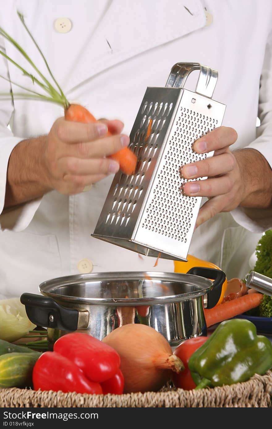 Cutting carrot with stainless grater in motion