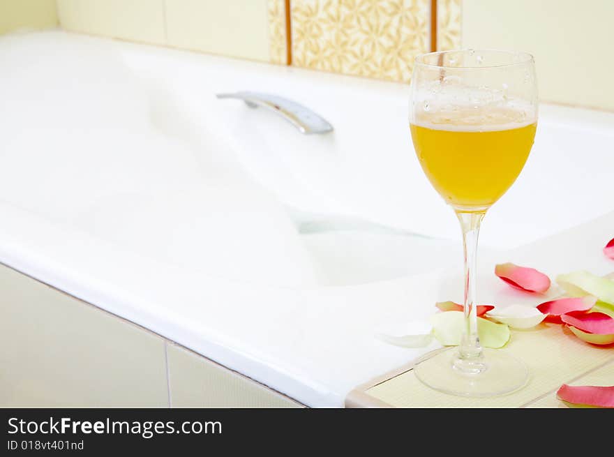 Still-life a glass with a drink against a bath with foam. Still-life a glass with a drink against a bath with foam