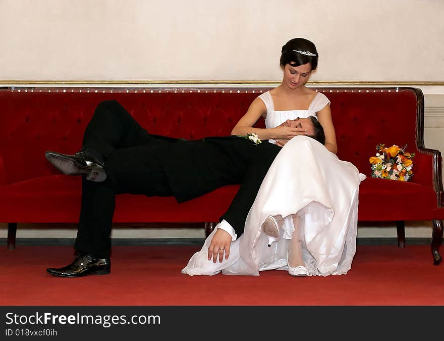 Bride and groom resting on a sofa. Bride and groom resting on a sofa