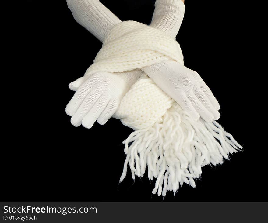 Hands in gloves and scarf on black background