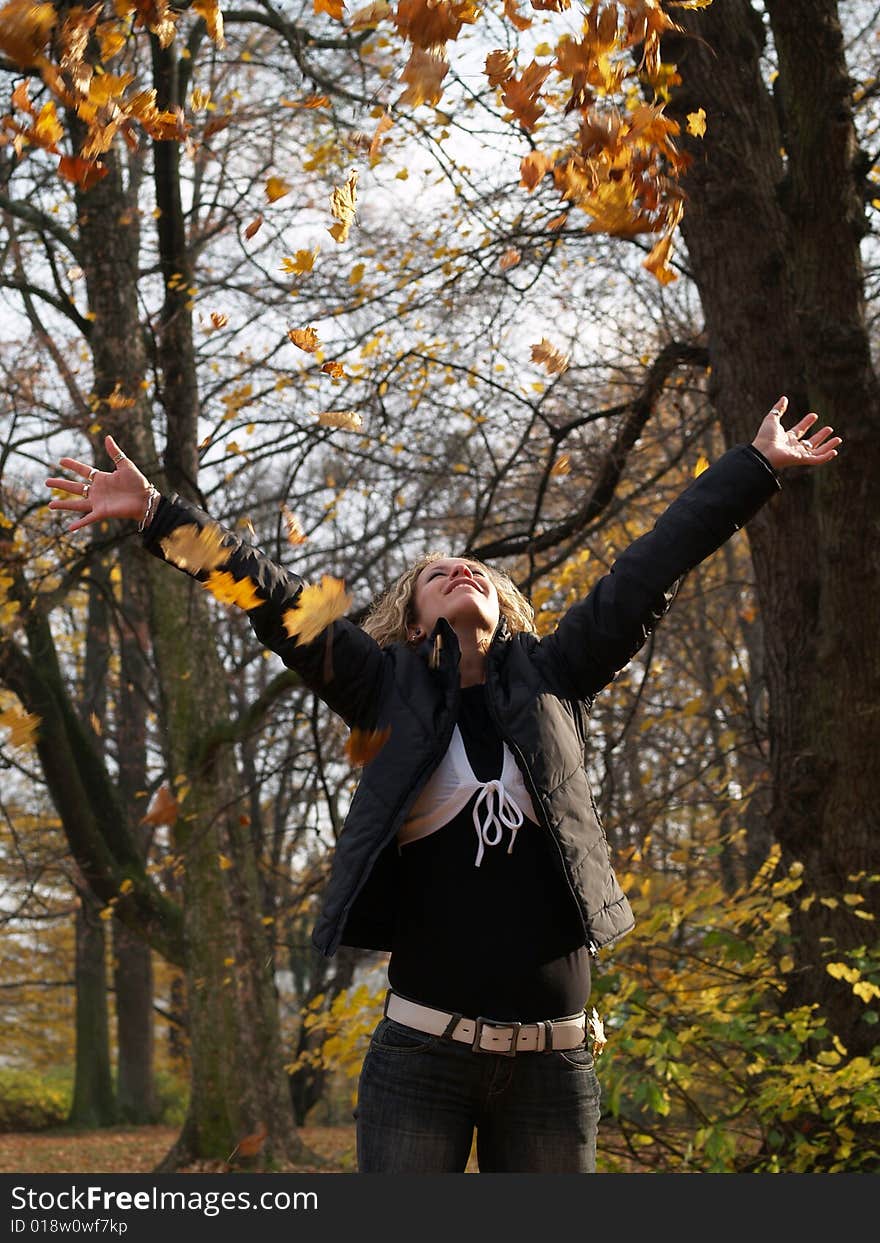 Happy girl in autumn garden