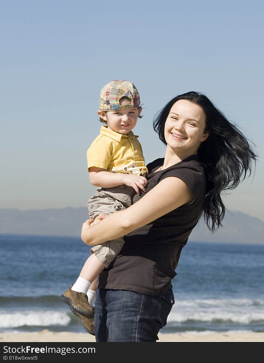 Young women holding little boy and having fun