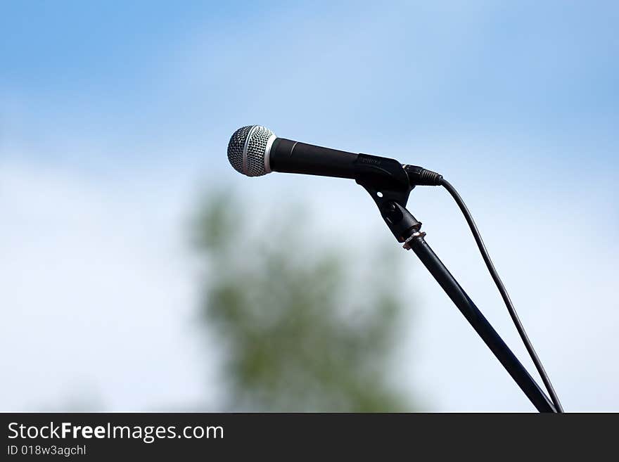 Microphone on sky background