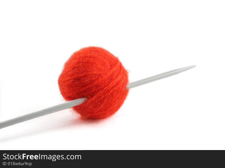 Wool yarn ball on the knitting needle, isolated on a white background. Wool yarn ball on the knitting needle, isolated on a white background