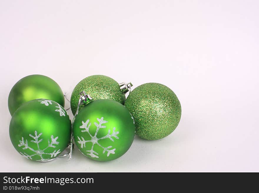 Five green christmas ornaments together. Five green christmas ornaments together