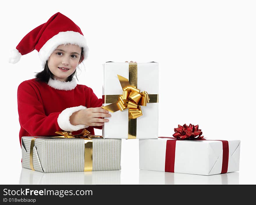 A little girl and xmas presents on white background. A little girl and xmas presents on white background