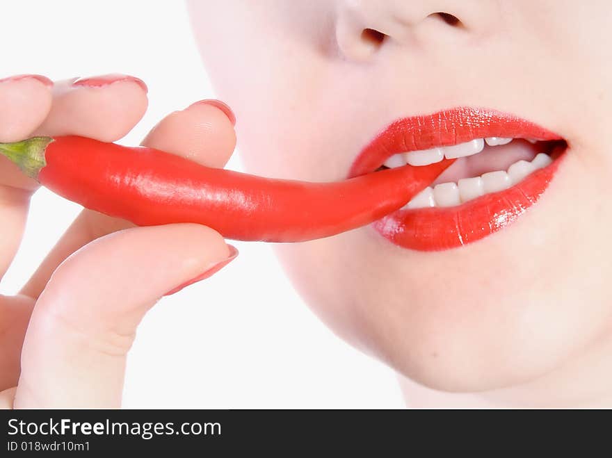 Girl is biting red hot chili pepper