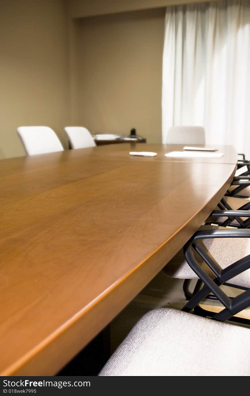 A modern office table in a workplace. A modern office table in a workplace.