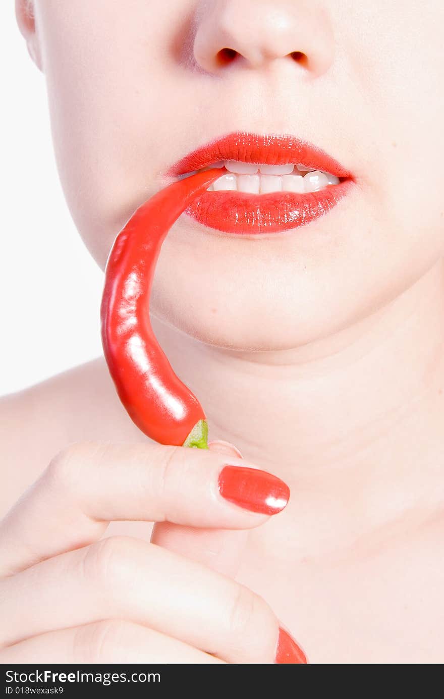 Girl is biting red hot chili pepper