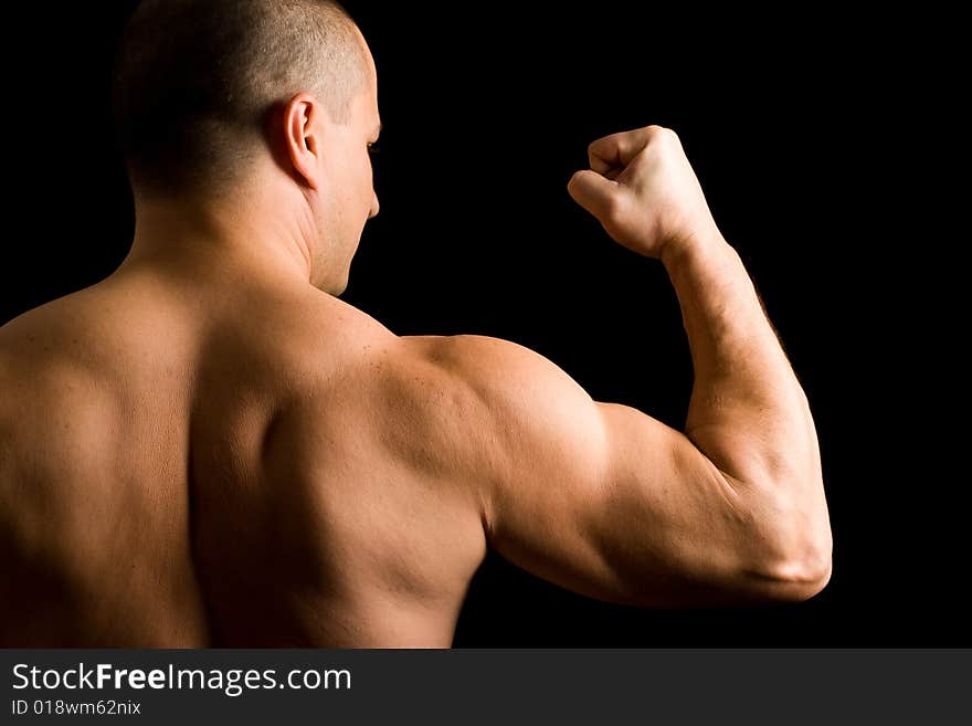 Young Muscular Man Flexing His Arm