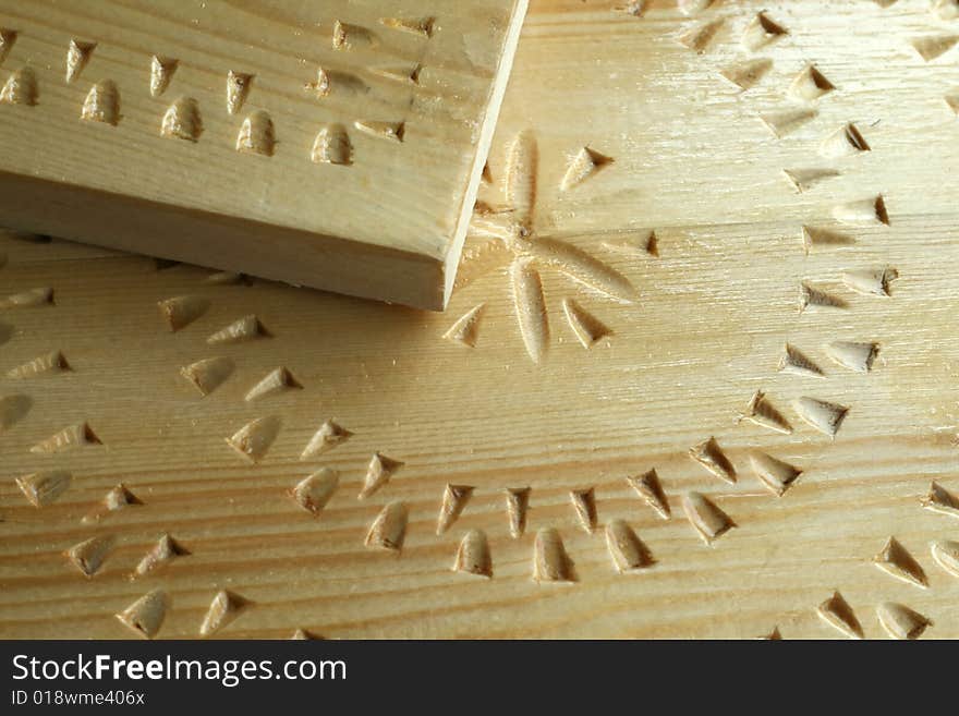 Woodcarving handwork,  light board  with a varnish covering, closeup