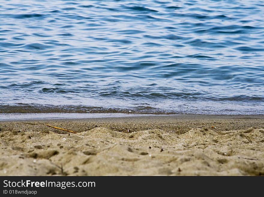 Seashore with blue water and sand