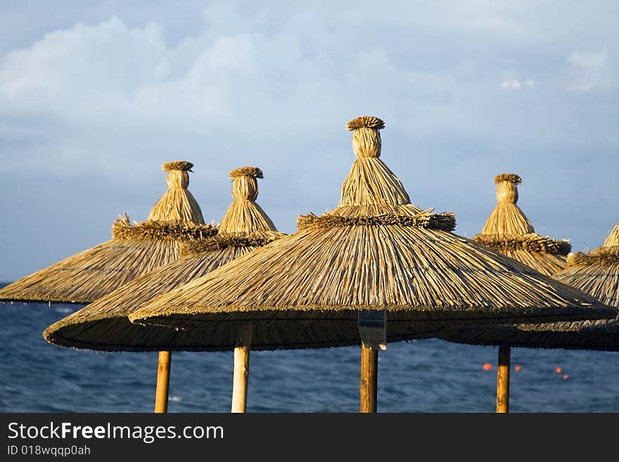 Seashore with beach umbrellas and seats