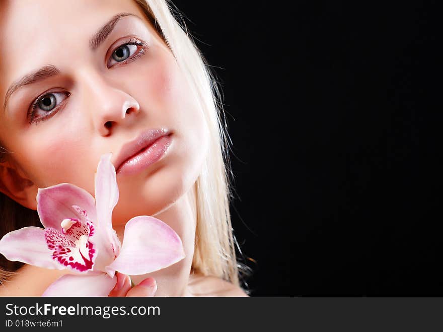 Face of beautiful young woman with delicate orchid. Face of beautiful young woman with delicate orchid