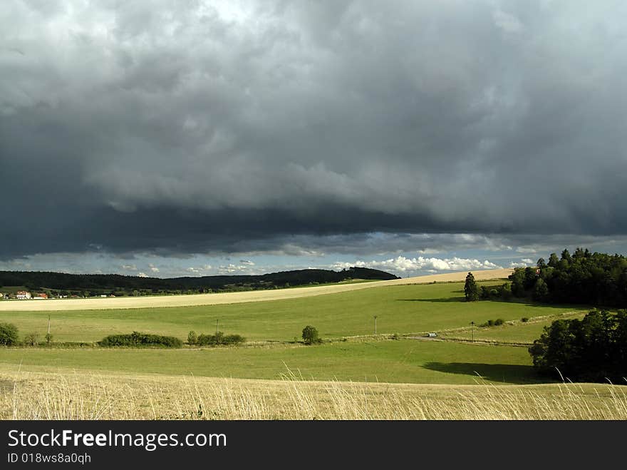 Summer landscape and heavy clouds