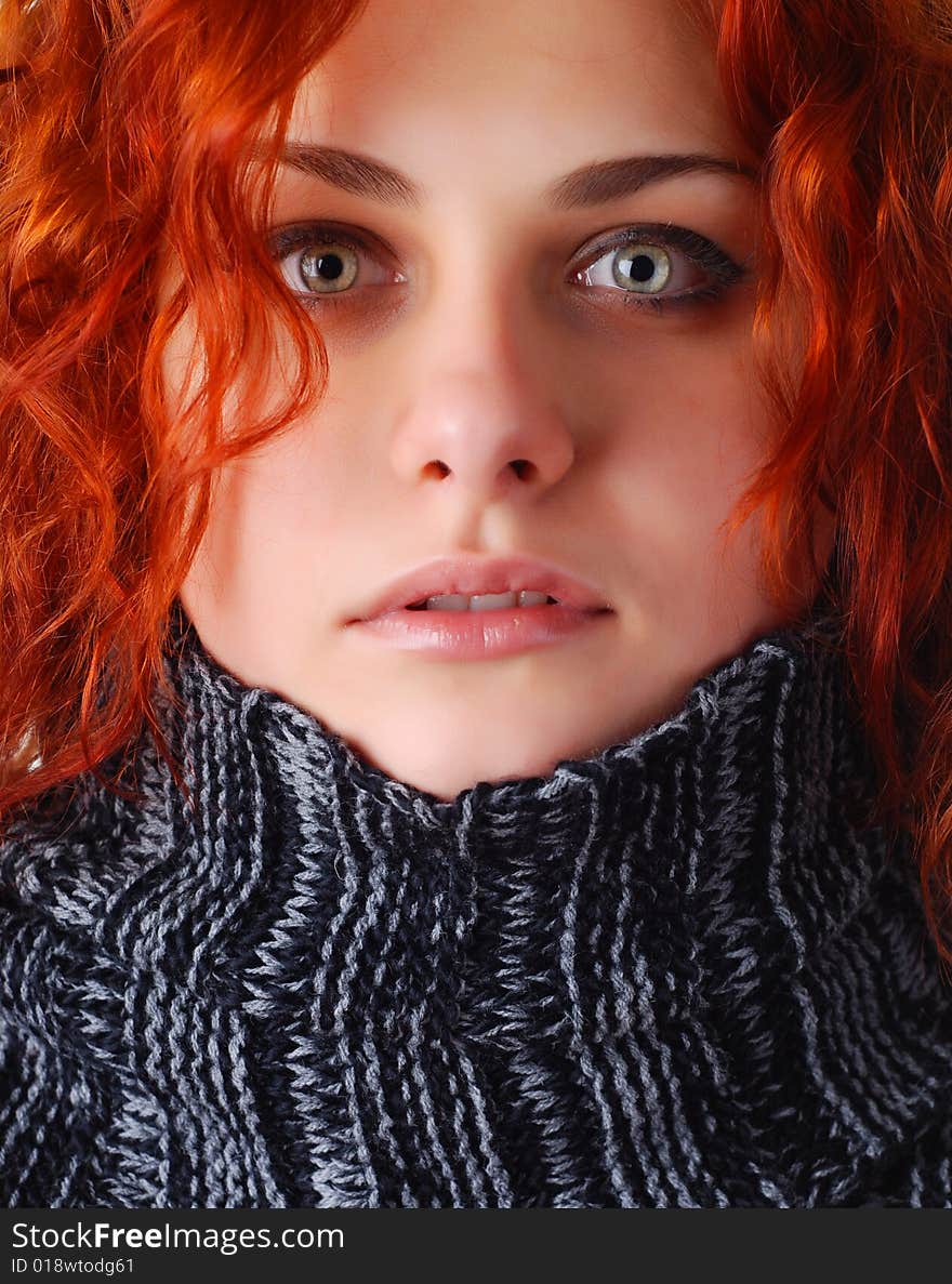 Portrait of a beautiful woman with red hair in a sweater. Portrait of a beautiful woman with red hair in a sweater