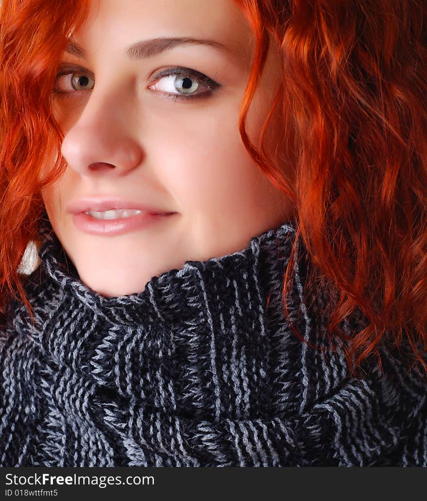 Portrait of a beautiful woman with red hair in a sweater. Portrait of a beautiful woman with red hair in a sweater