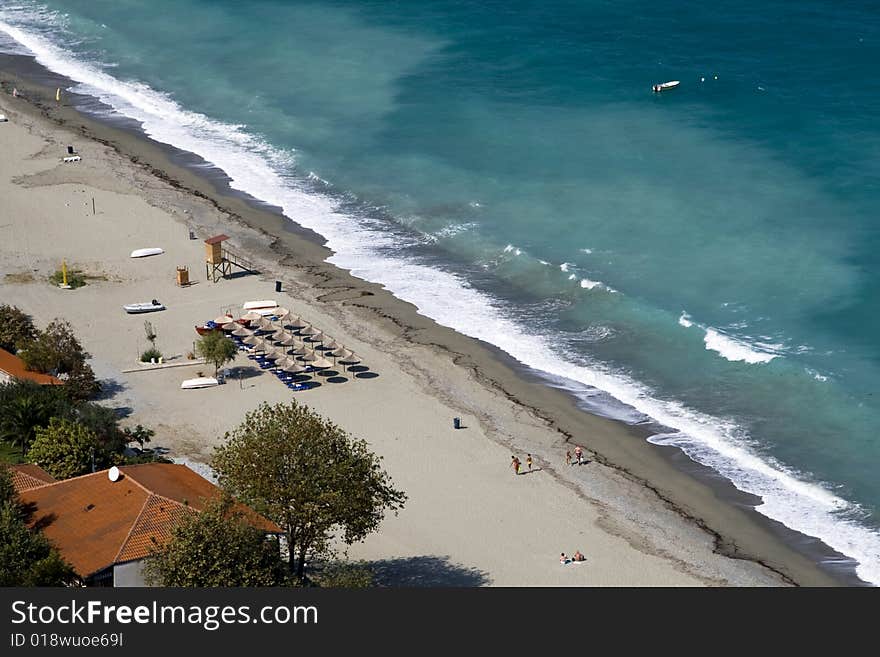 Seashore with beach umbrellas and seats