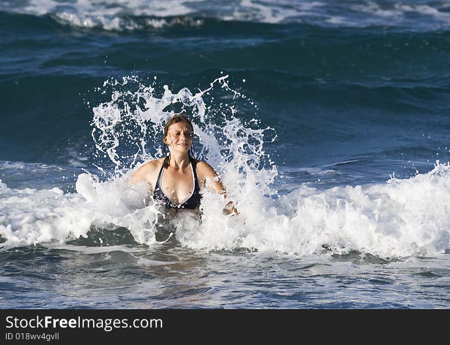 Young woman having a bath in the sea