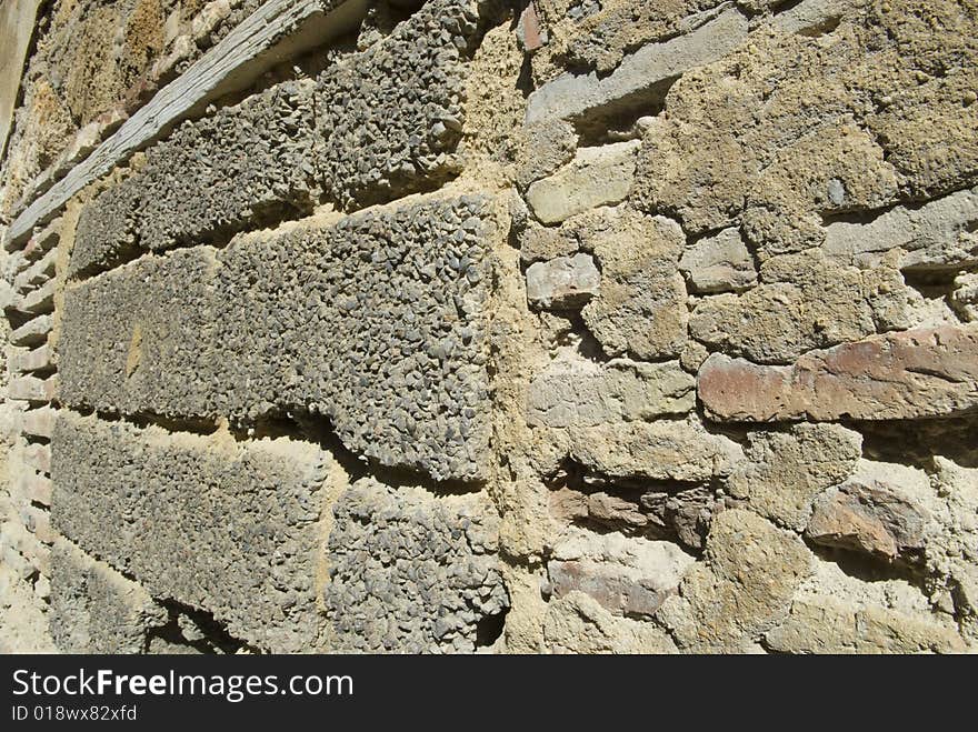 Stone rock and rouhg cement block wall wood beam