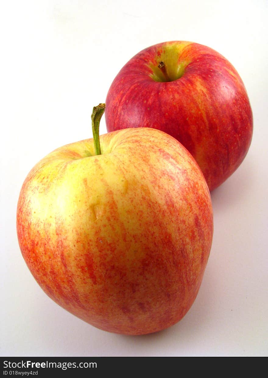 A pair of red apples on a white background. A pair of red apples on a white background