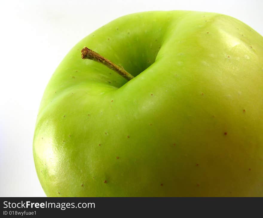 Close-up of a golden delicious apple on white background