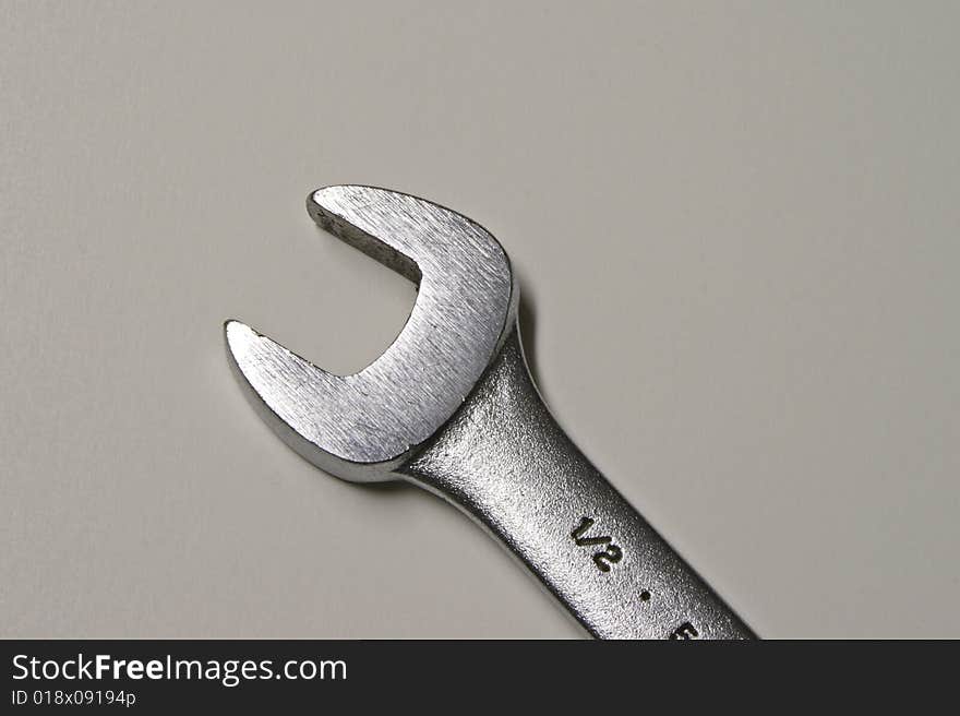 A half inch open end wrench against a gray background