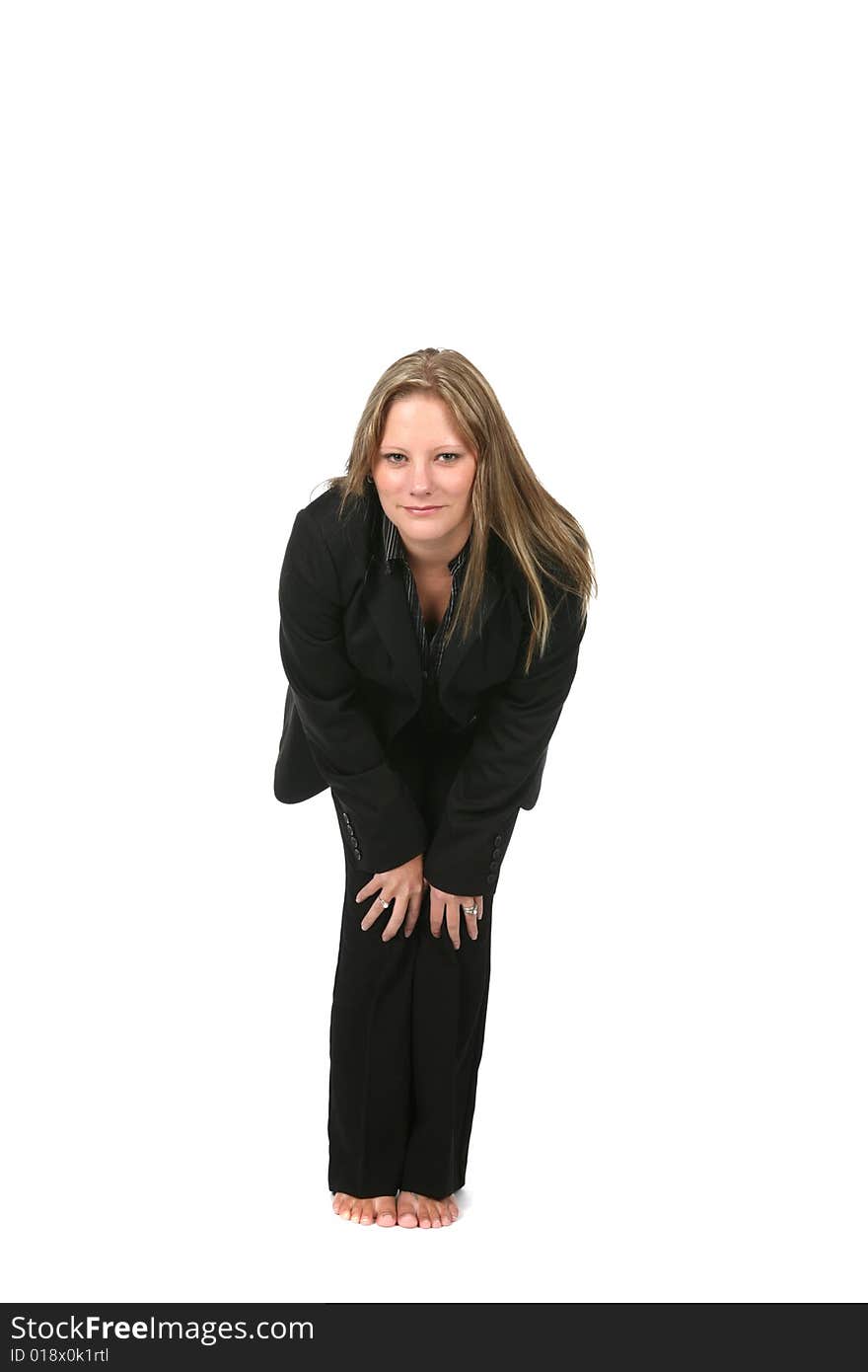 Professional woman in black bending forward with hands on her knees. Professional woman in black bending forward with hands on her knees