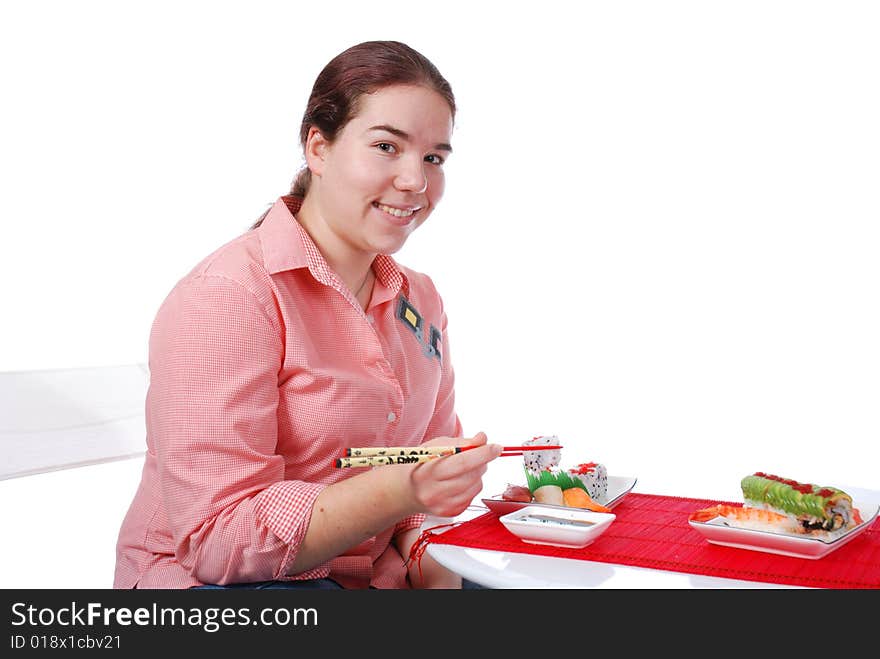 One girl eating rolls and sushi. One girl eating rolls and sushi