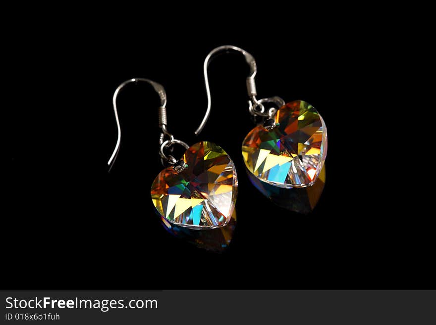 A pair of earrings isolated on black background.