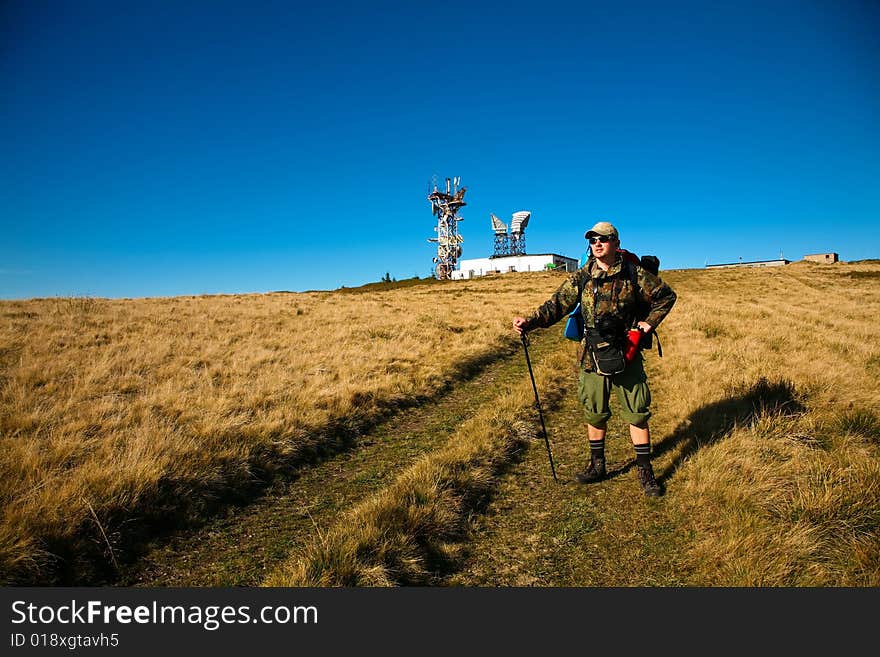 An image of a tourist walking in mountains. An image of a tourist walking in mountains