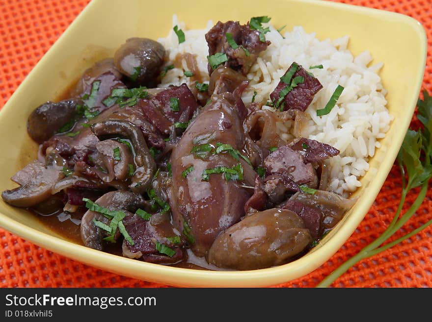 Chicken meat in red wine sauce and boiled rice