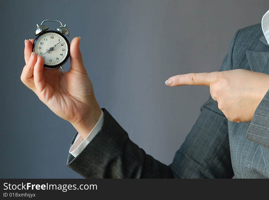 The young businesswoman hold the clock in the hand