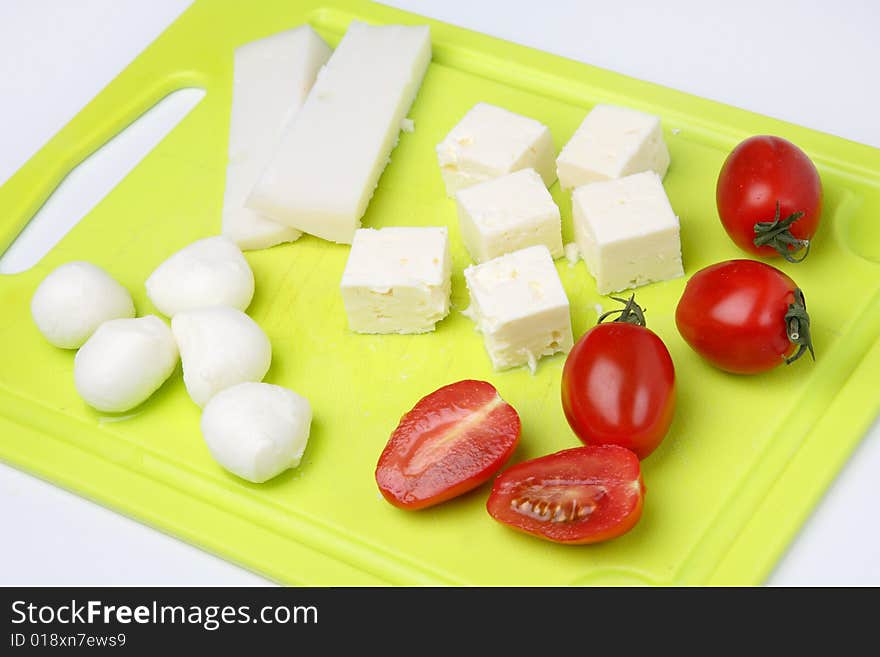 Different cheeses and tomato