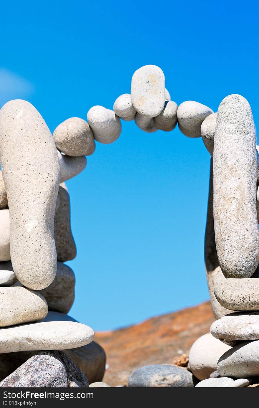 Arch from a sea pebble on a beach in the summer. Arch from a sea pebble on a beach in the summer